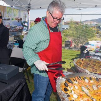 man making paella at farmers market