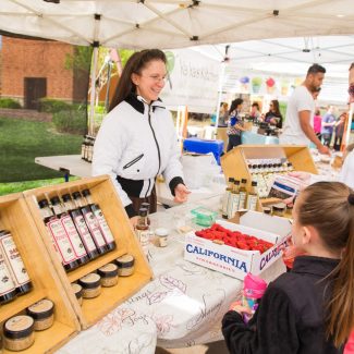 woman selling oil at a farmers market