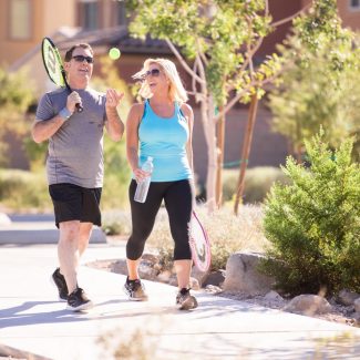 couple walking to play tennis