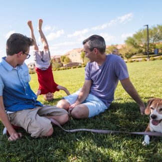 boy doing a headstand in front of family