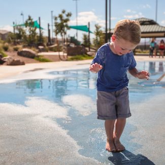 boy playing in splash pad