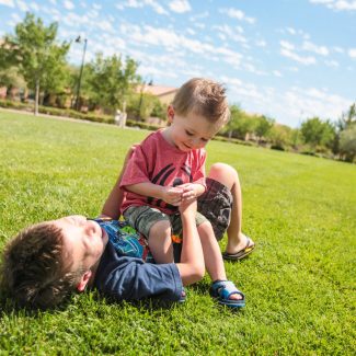 brothers playing in park