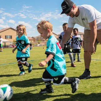 little kids playing soccer