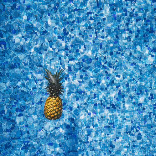 pineapple floating in a pool