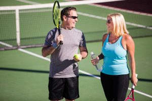 A man and woman converse with each other during a Pickleball tournament.