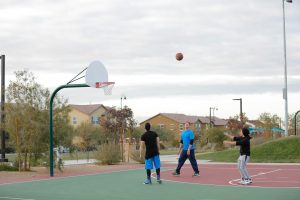 boys playing basketball at park