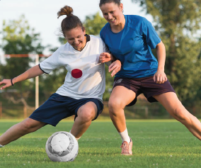 women jockeying for position while playing soccer