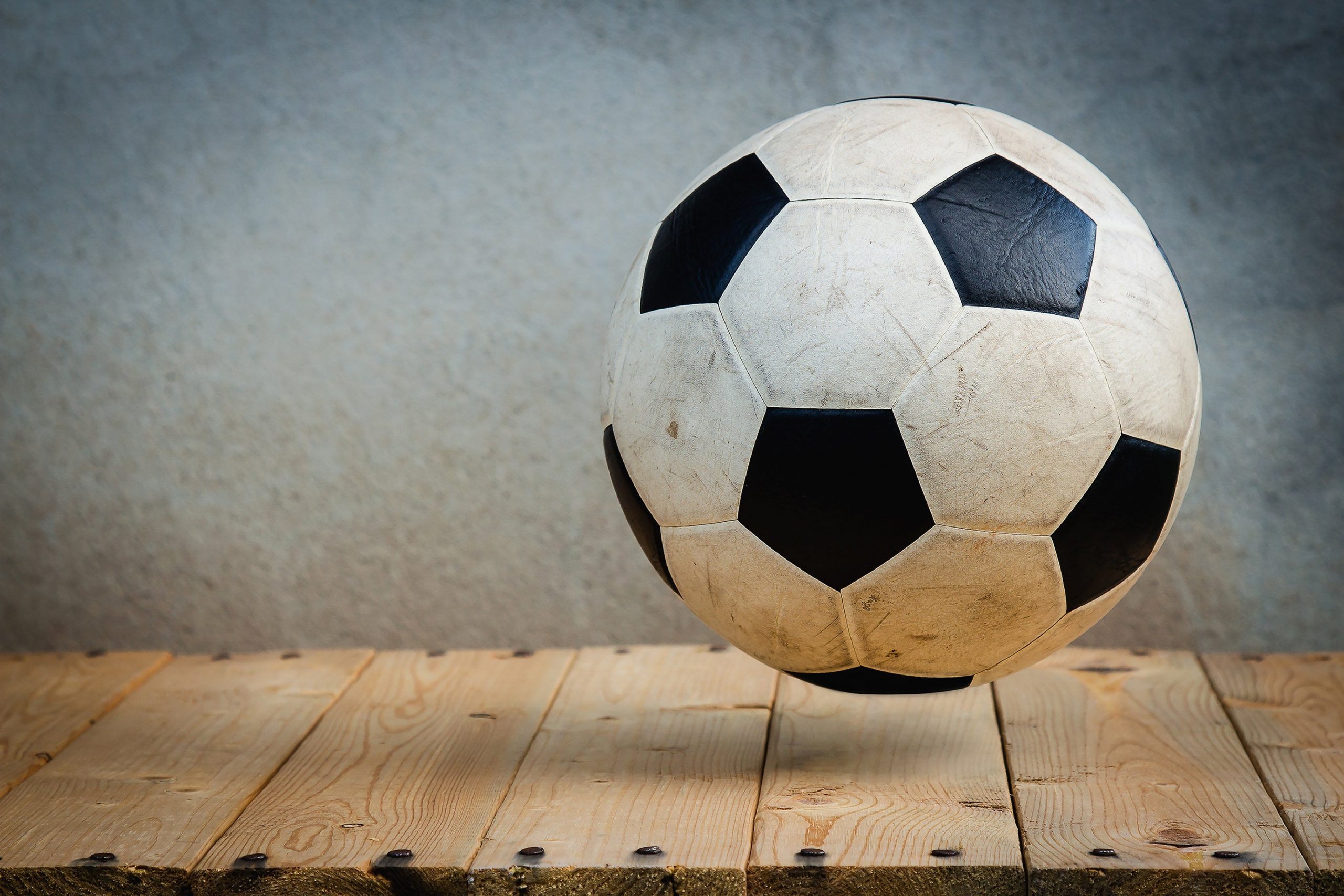 A soccer ball on a wooden floor