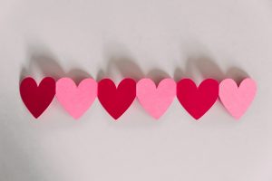 Pink and red hearts on a white background