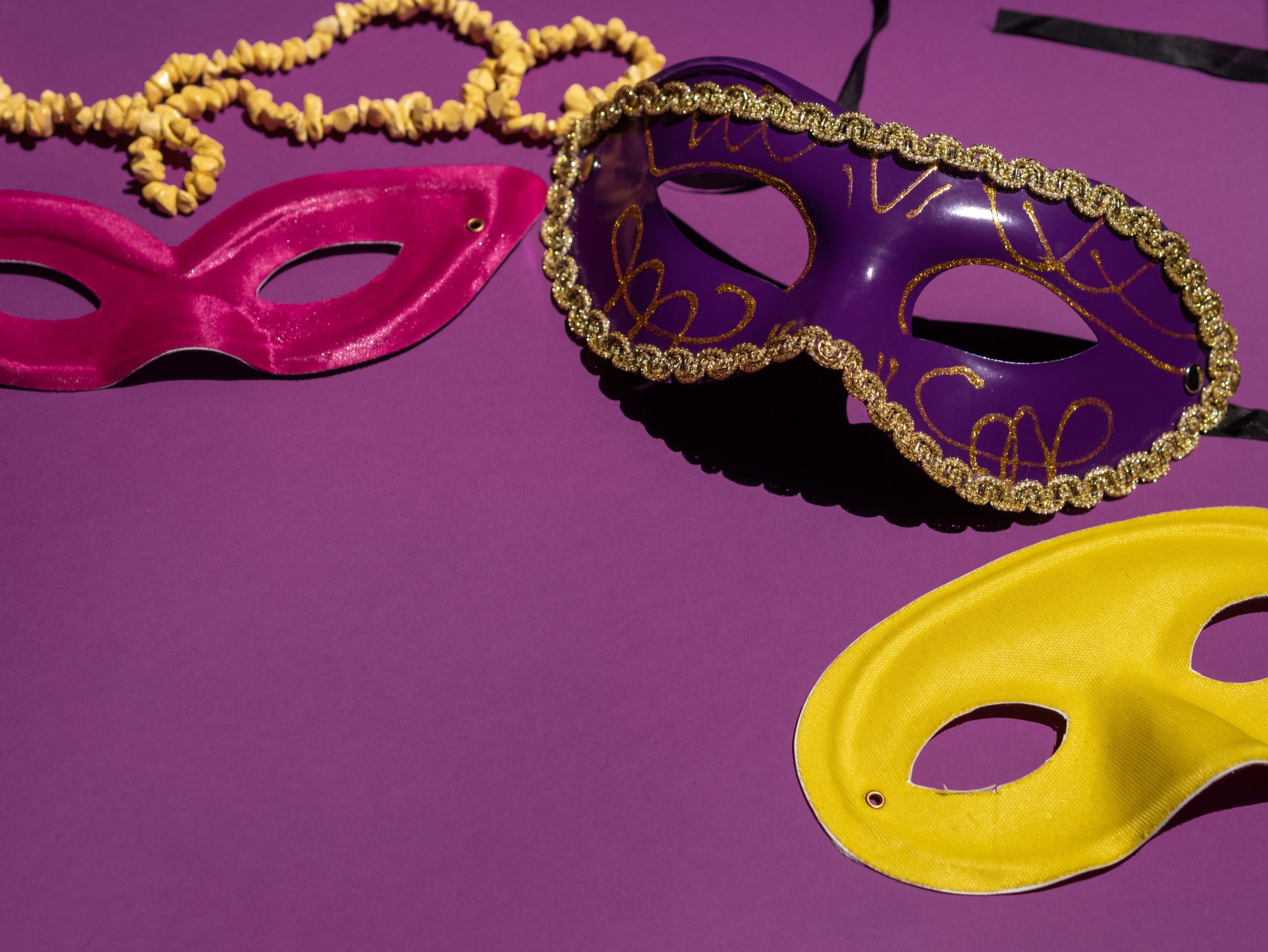 Mardi Gras masks on a purple background