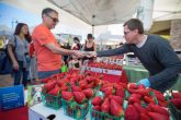 man buying strawberries at farmers market