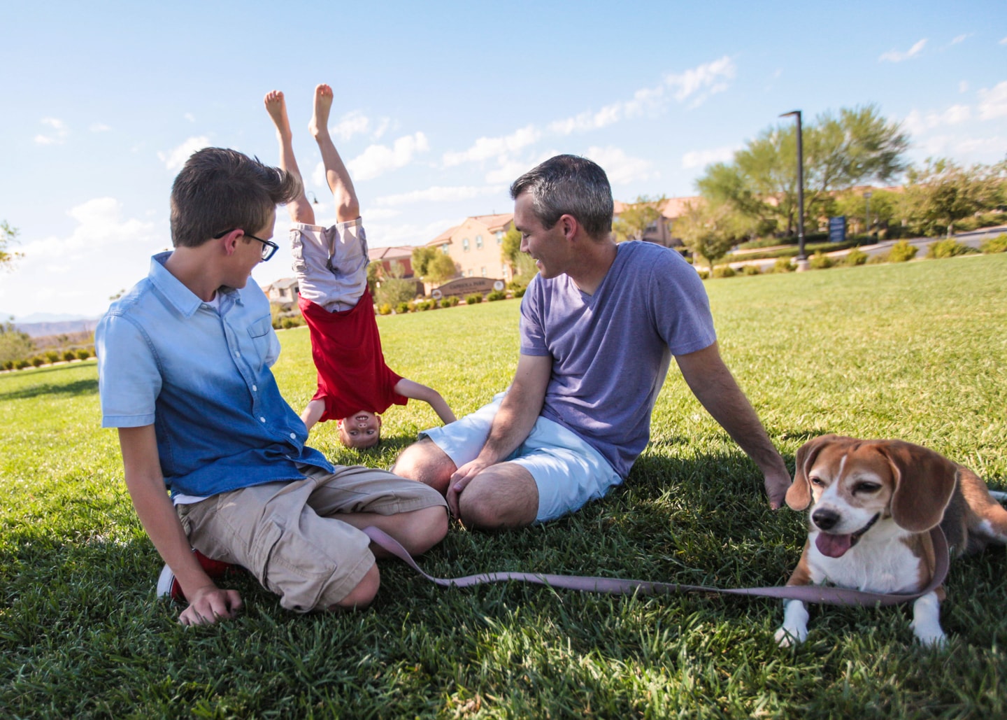 boy doing a headstand in front of family