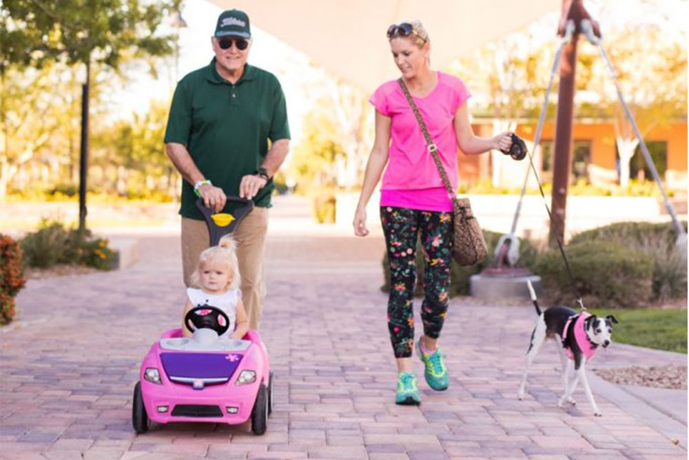 family walking dog and child