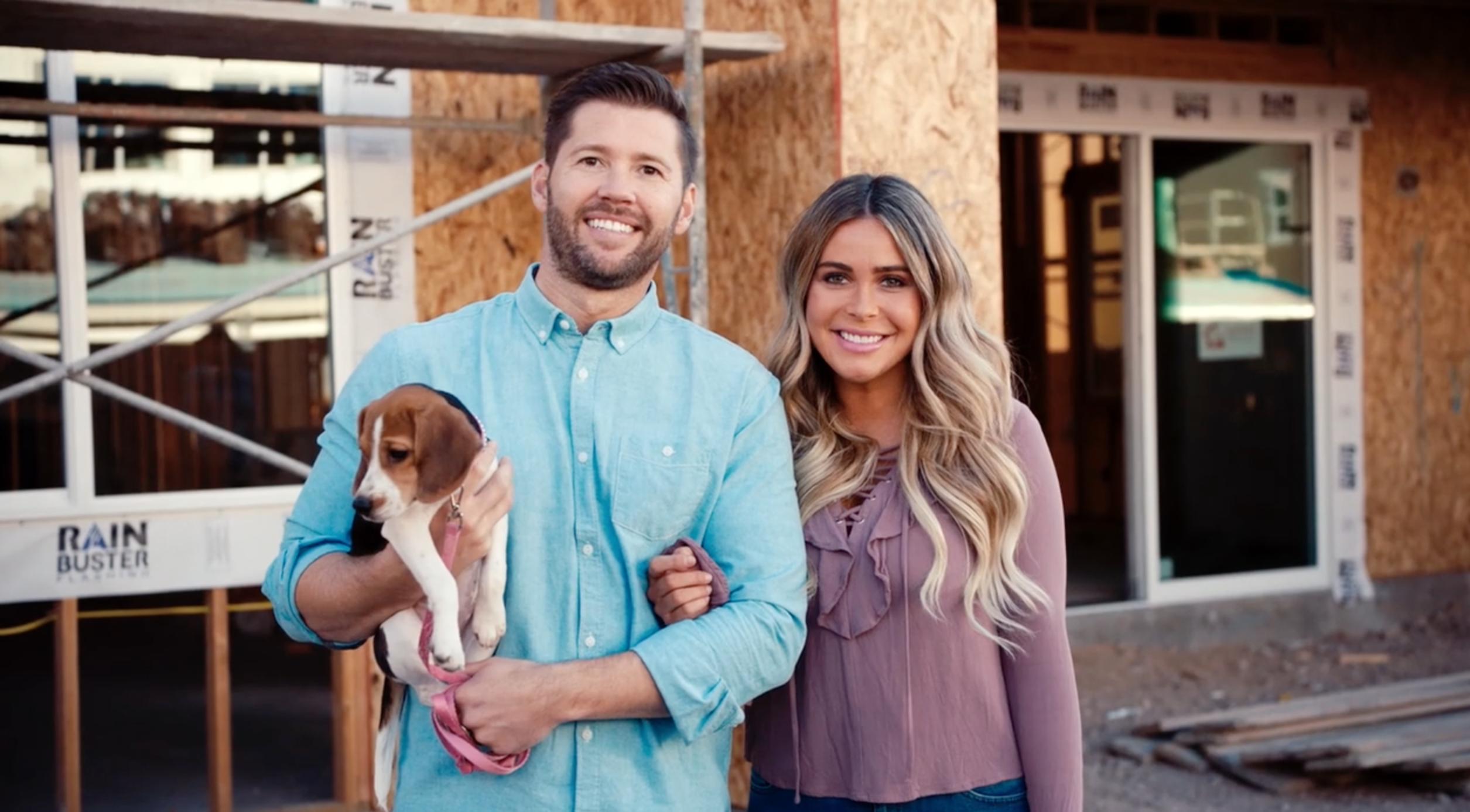 couple in front of home construction