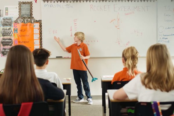 kid teaching class about rocket experiment