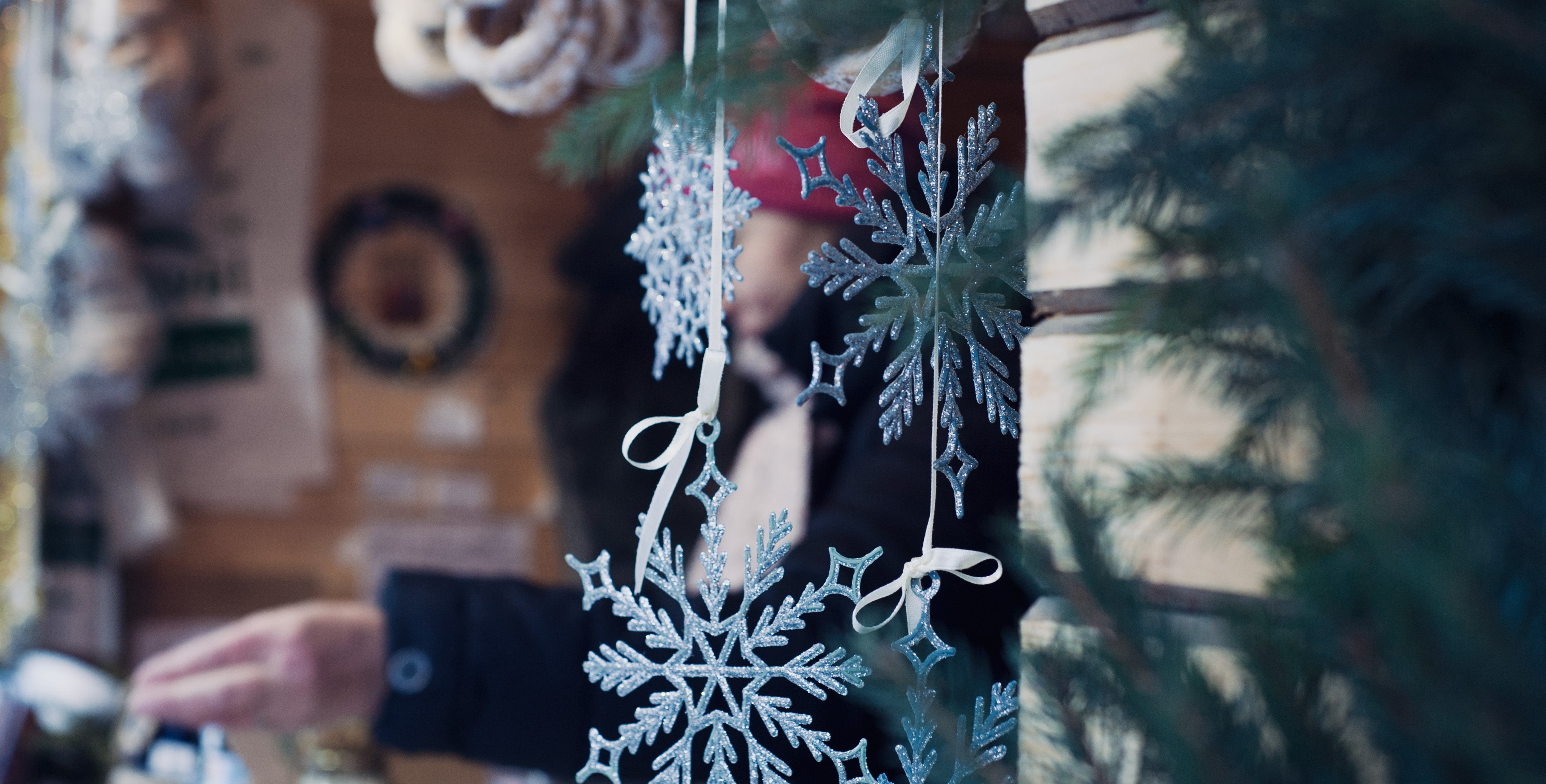 Blue snowflakes hang from a string at the Holiday Vintage Market & Craft Sale