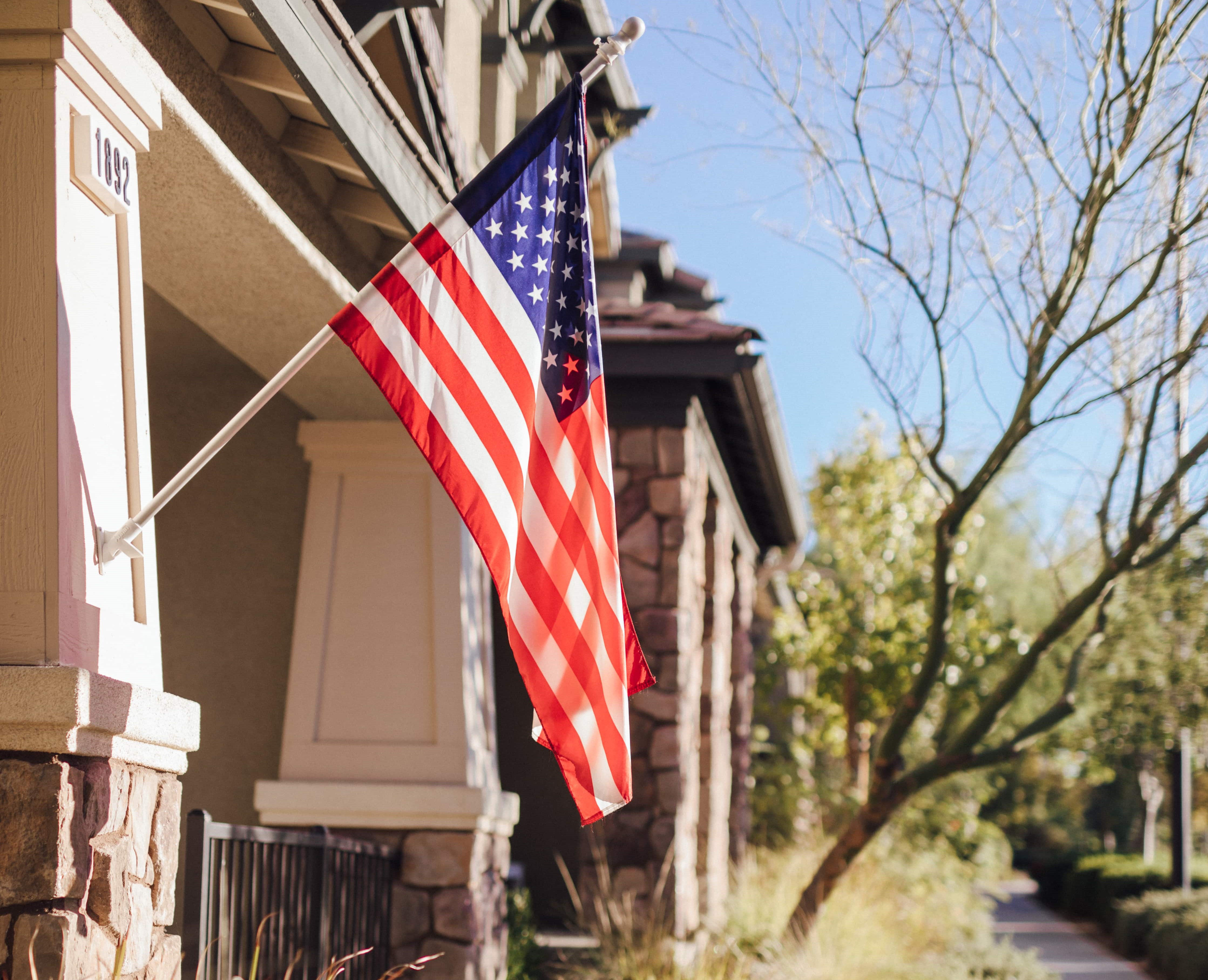 american flag hanging outside townhome