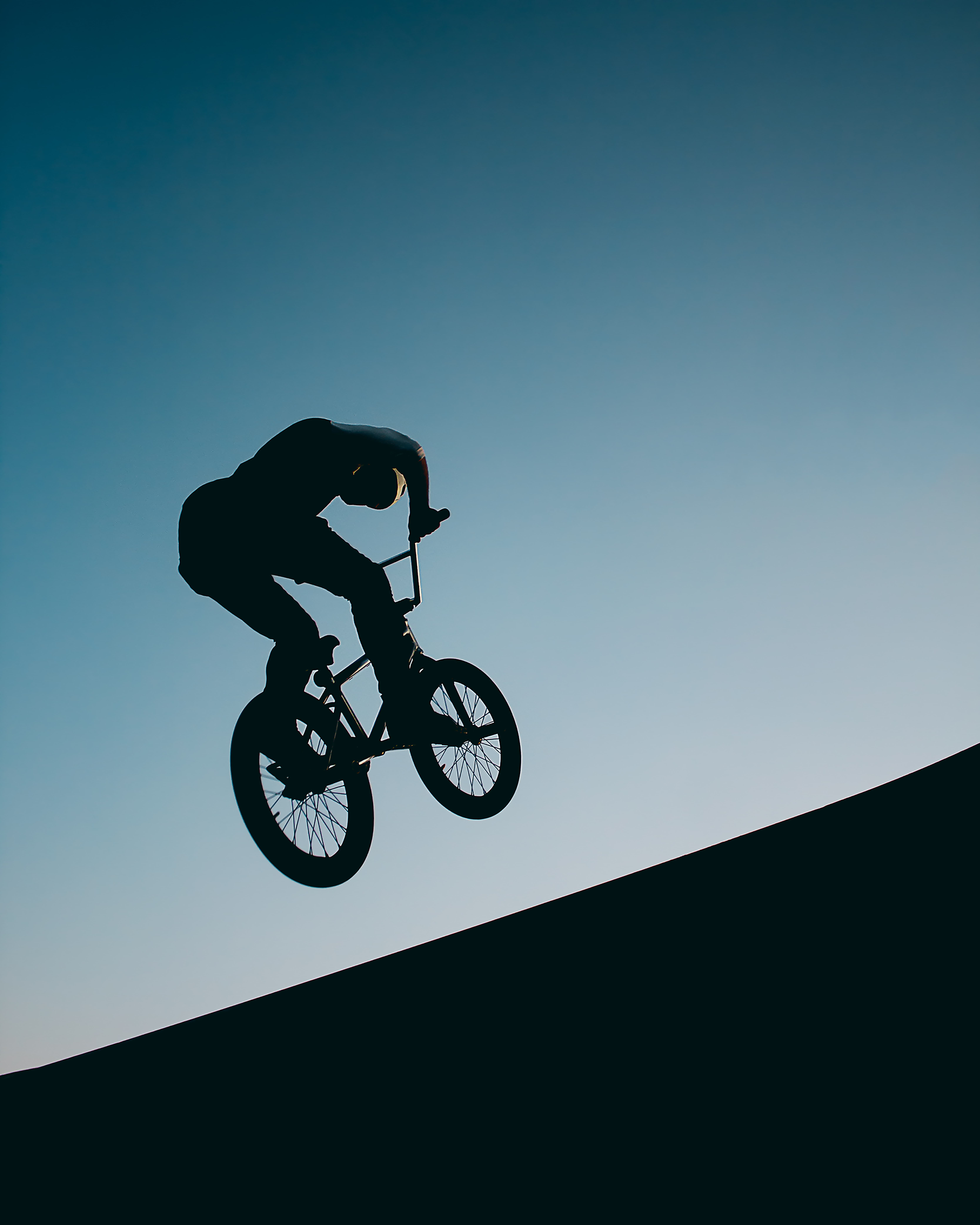 Man jumping on a bike.