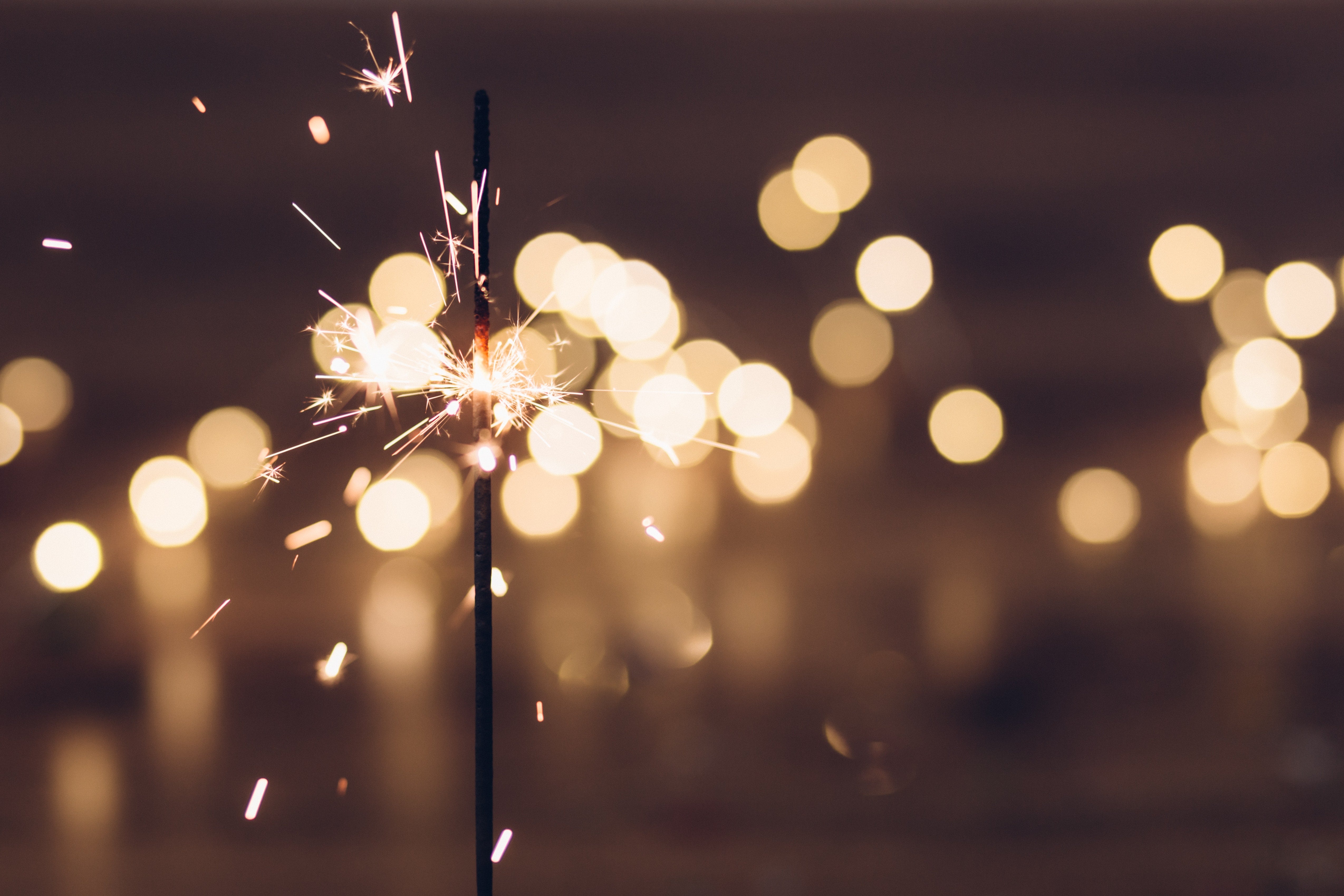 A sparkler lights up the night sky during a New Year's celebration.