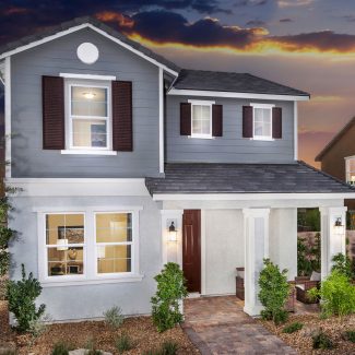 Light blue 2-story house in dusk.