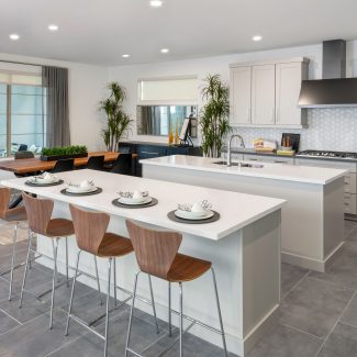 An open kitchen with two white islands.