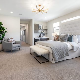 Clean, light master bedroom with two windows