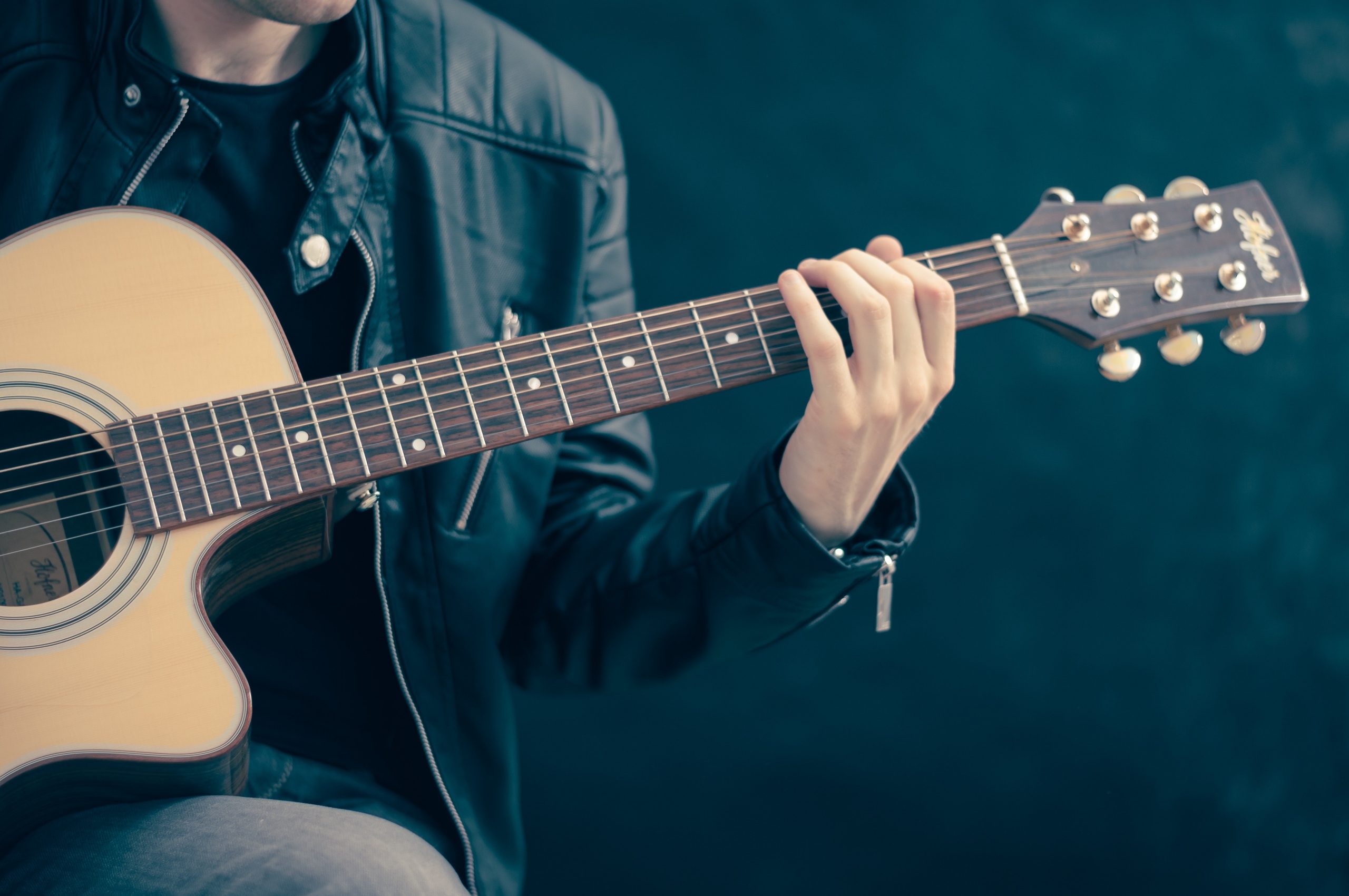 A man plays an acoustic guitar